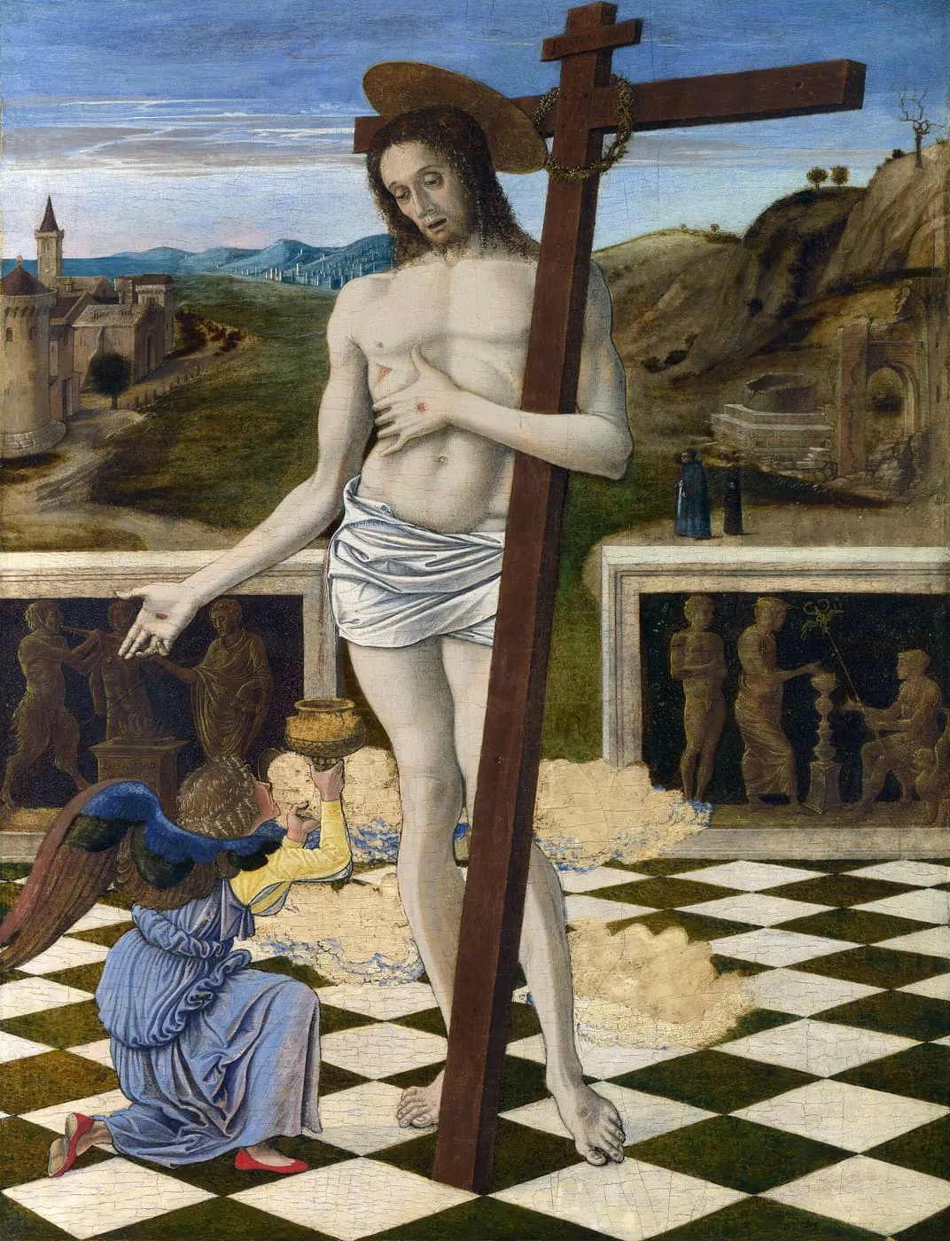Chrystus oparty o krzyż wskazuje ranę w boku, a klęczący anioł wznosi kielich, do którego spływa Jego krew — „Krew Odkupiciela” Giovanniego Belliniego z lat 1460–1465